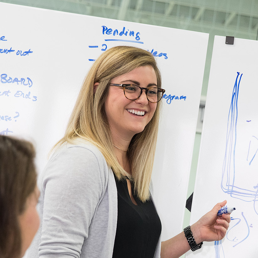Student presenting at a whiteboard